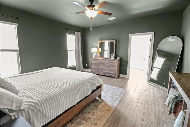 39593 Fly Creek Rd, Ponchatoula, LA 70454 - bedroom featuring wood finished floors, multiple windows, baseboards, and a ceiling fan