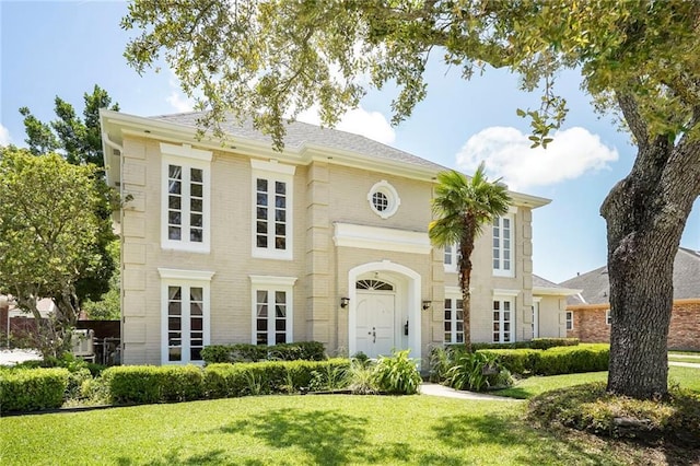 2442 Killdeer St, New Orleans, LA 70122 - georgian-style home with a front lawn and brick siding