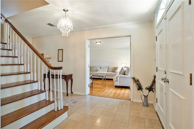 2442 Killdeer St, New Orleans, LA 70122 - entryway featuring stairs, ornamental molding, light tile patterned flooring, a chandelier, and baseboards