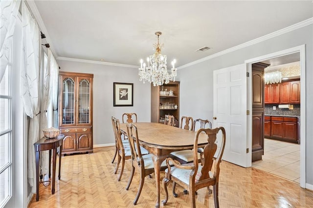 2442 Killdeer St, New Orleans, LA 70122 - dining area with a chandelier, baseboards, and crown molding