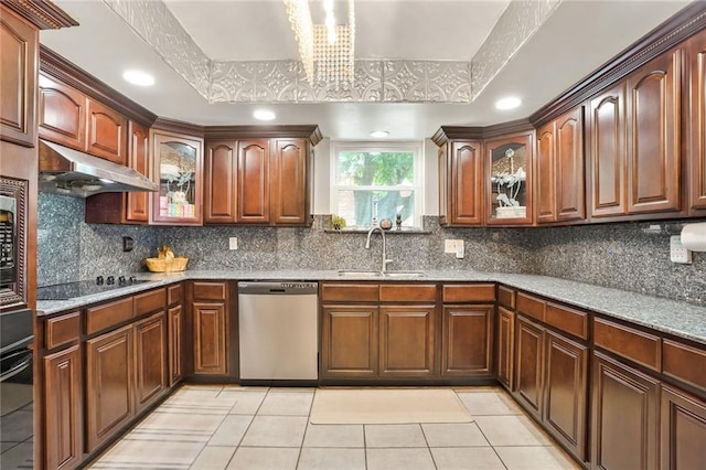 2442 Killdeer St, New Orleans, LA 70122 - kitchen with black appliances, a sink, under cabinet range hood, light tile patterned floors, and glass insert cabinets