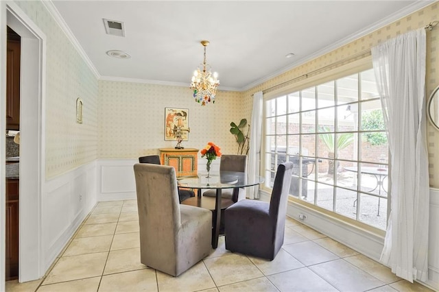 2442 Killdeer St, New Orleans, LA 70122 - dining space with a chandelier, wainscoting, ornamental molding, light tile patterned floors, and wallpapered walls