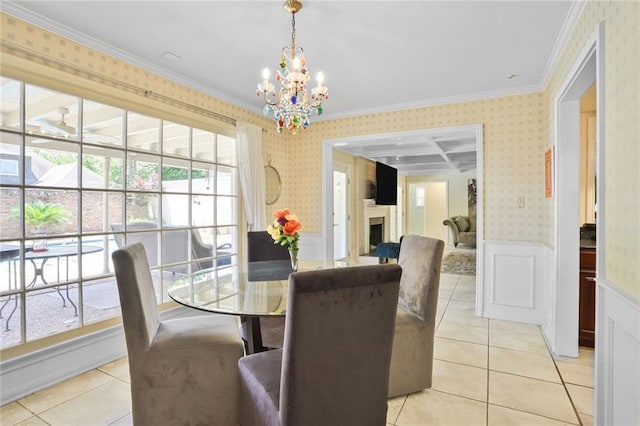 2442 Killdeer St, New Orleans, LA 70122 - dining area with wallpapered walls, wainscoting, a chandelier, light tile patterned floors, and ornamental molding