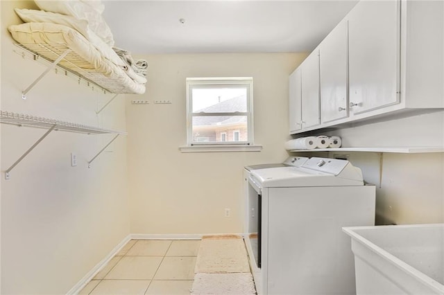 2442 Killdeer St, New Orleans, LA 70122 - laundry room featuring cabinet space, independent washer and dryer, baseboards, and light tile patterned flooring