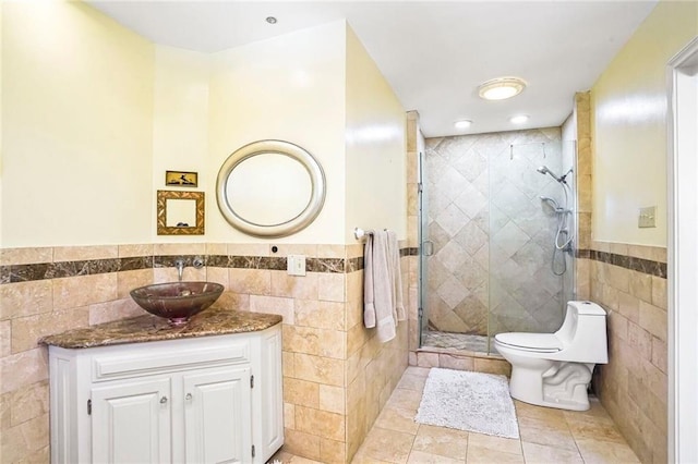 2442 Killdeer St, New Orleans, LA 70122 - bathroom with tile walls, a stall shower, vanity, tile patterned floors, and a wainscoted wall