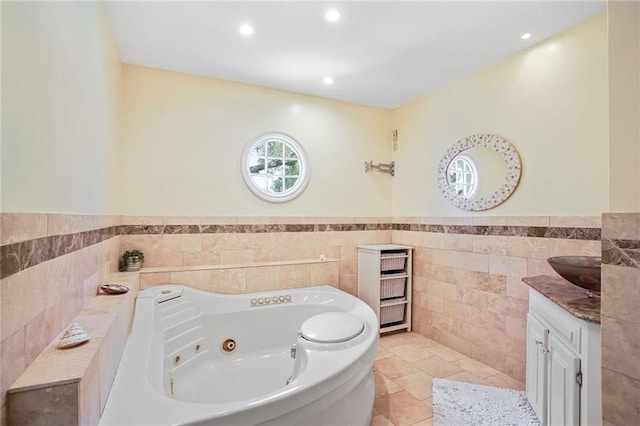 2442 Killdeer St, New Orleans, LA 70122 - full bath with tile walls, vanity, a whirlpool tub, wainscoting, and recessed lighting