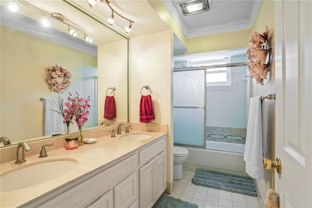 2442 Killdeer St, New Orleans, LA 70122 - full bathroom with crown molding, double vanity, tile patterned floors, toilet, and bath / shower combo with glass door