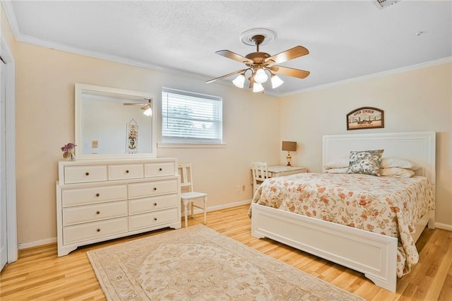 2442 Killdeer St, New Orleans, LA 70122 - bedroom with ornamental molding, light wood-type flooring, baseboards, and ceiling fan