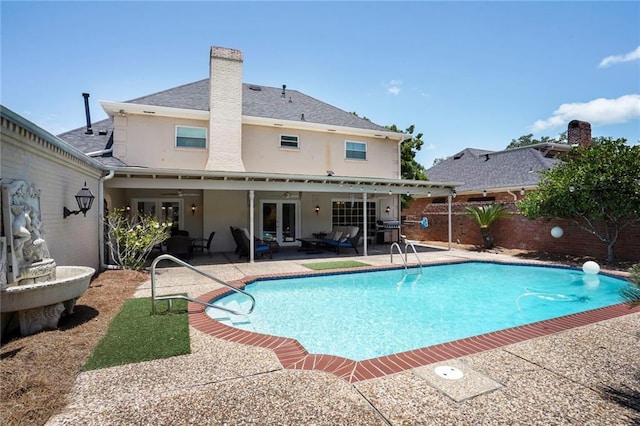 2442 Killdeer St, New Orleans, LA 70122 - view of swimming pool with french doors, a patio, and a fenced backyard