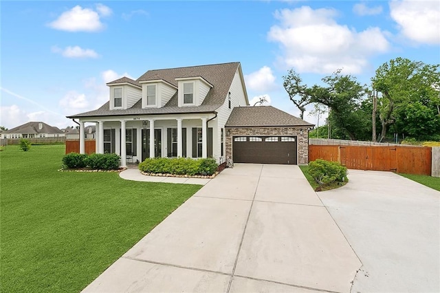 9574 W Terran Ln, Waggaman, LA 70094 - cape cod home with a garage, driveway, roof with shingles, and covered porch
