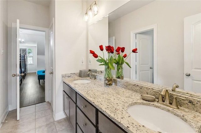 9574 W Terran Ln, Waggaman, LA 70094 - ensuite bathroom featuring baseboards, double vanity, and tile patterned floors