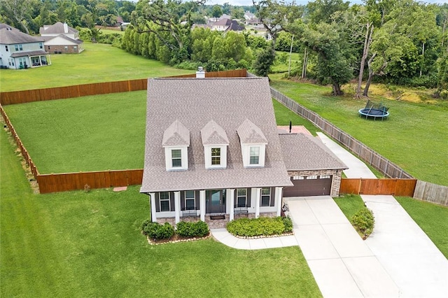 9574 W Terran Ln, Waggaman, LA 70094 - view of front of property featuring an attached garage, stone siding, driveway, roof with shingles, and a chimney