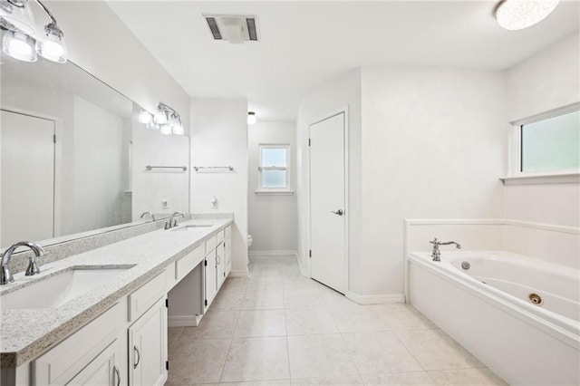 310 Scotchpine Dr, Mandeville, LA 70471 - full bathroom featuring double vanity, a jetted tub, and tile patterned floors