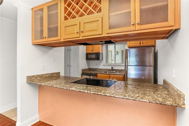 3805 Houma Blvd Unit C101, Metairie, LA 70006 - kitchen with black appliances, a sink, stone countertops, crown molding, and baseboards