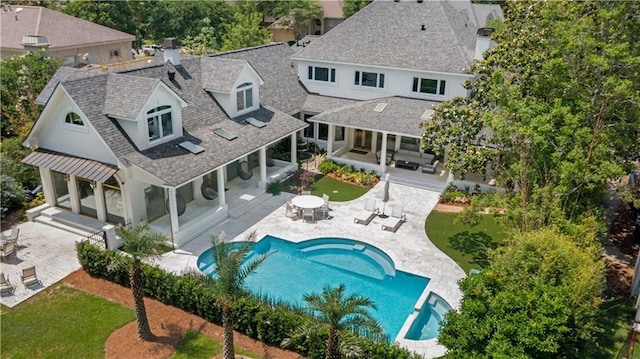 139 Fontainbleau Dr, Mandeville, LA 70471 - back of property featuring an outdoor living space, roof with shingles, a patio area, an outdoor pool, and a chimney