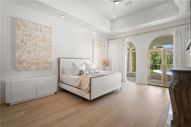 139 Fontainbleau Dr, Mandeville, LA 70471 - bedroom featuring radiator, access to exterior, light wood-style floors, a tray ceiling, and recessed lighting
