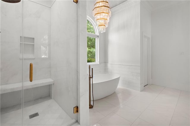 139 Fontainbleau Dr, Mandeville, LA 70471 - full bathroom with a stall shower, a freestanding tub, ornamental molding, and a chandelier