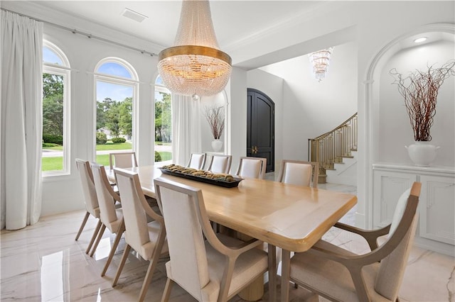 139 Fontainbleau Dr, Mandeville, LA 70471 - dining space with a chandelier, stairs, plenty of natural light, and light marble finish flooring