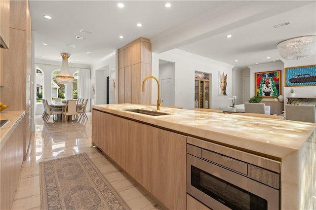 139 Fontainbleau Dr, Mandeville, LA 70471 - kitchen featuring a sink, modern cabinets, light brown cabinetry, stainless steel microwave, and butcher block countertops