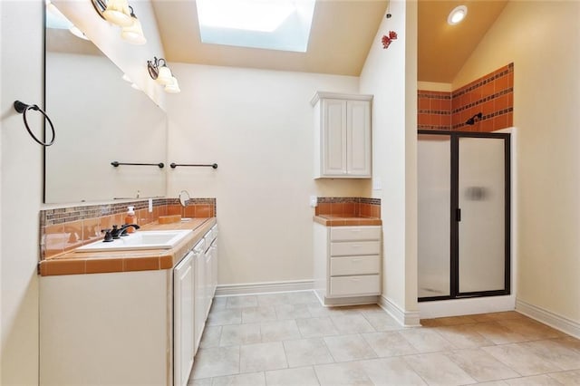 26545 Mildred Dr, Lacombe, LA 70445 - full bathroom featuring a skylight, a shower stall, vanity, decorative backsplash, and lofted ceiling