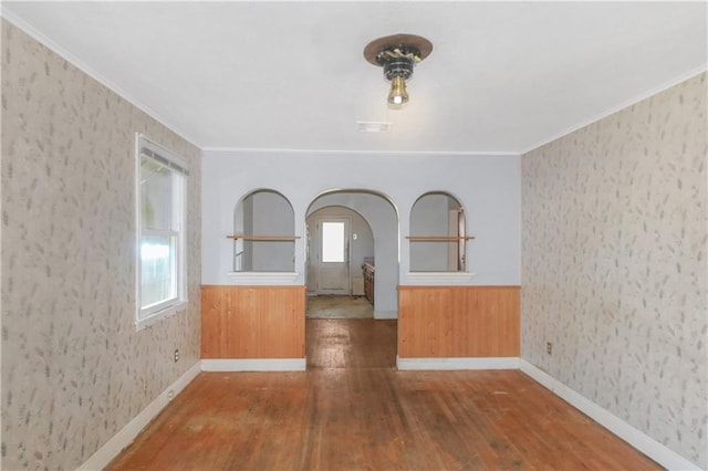 717 E Jefferson Park, Jefferson, LA 70121 - spare room with hardwood / wood-style flooring, arched walkways, plenty of natural light, crown molding, and wainscoting