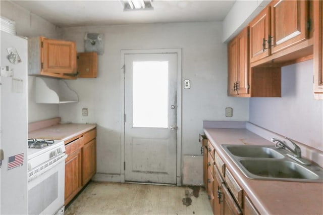 717 E Jefferson Park, Jefferson, LA 70121 - kitchen with white gas stove, light countertops, brown cabinetry, and light wood-style floors