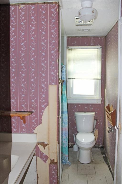 717 E Jefferson Park, Jefferson, LA 70121 - bathroom featuring wallpapered walls, toilet, and tile patterned flooring