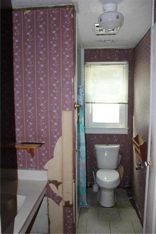717 E Jefferson Park, Jefferson, LA 70121 - bathroom featuring toilet, wallpapered walls, and tile patterned floors