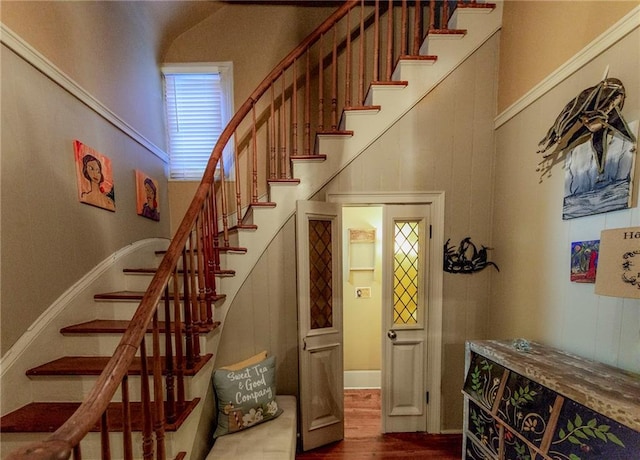 723 Kerlerec St, New Orleans, LA 70116 - staircase with wood finished floors and a high ceiling