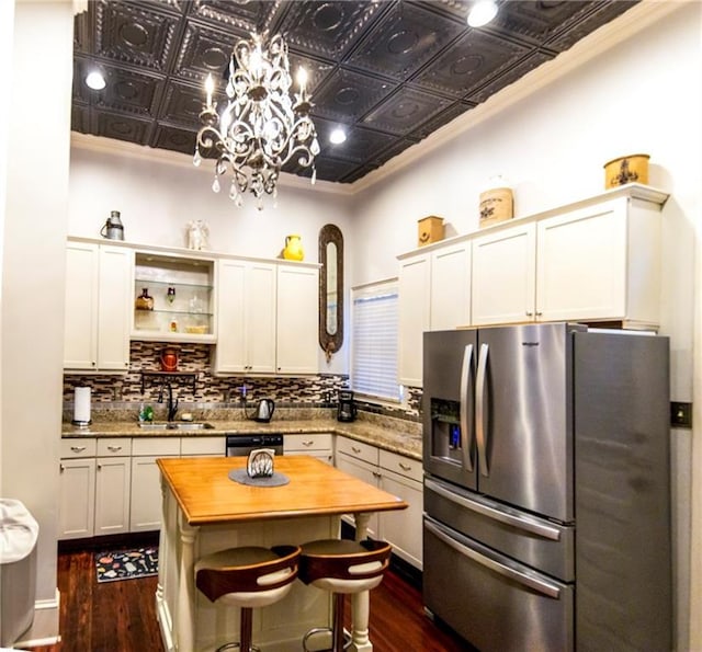 723 Kerlerec St, New Orleans, LA 70116 - kitchen with stainless steel appliances, an ornate ceiling, butcher block countertops, a chandelier, and dark wood-type flooring