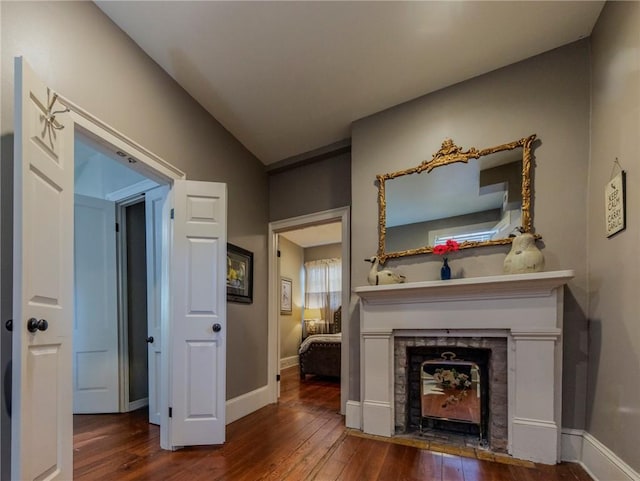 723 Kerlerec St, New Orleans, LA 70116 - living area featuring hardwood / wood-style flooring, a fireplace with flush hearth, and lofted ceiling