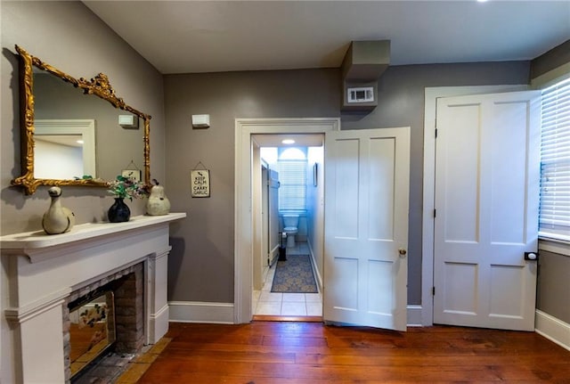 723 Kerlerec St, New Orleans, LA 70116 - foyer featuring wood-type flooring and a fireplace with flush hearth