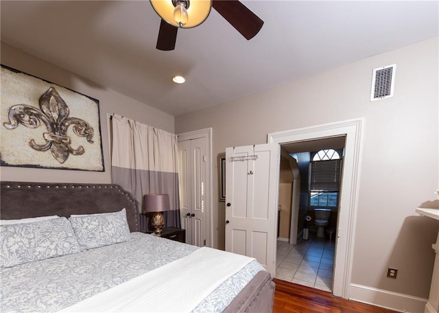 723 Kerlerec St, New Orleans, LA 70116 - bedroom featuring dark wood-type flooring, a closet, connected bathroom, and ceiling fan