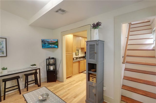 723 Kerlerec St, New Orleans, LA 70116 - stairway featuring wood finished floors and baseboards
