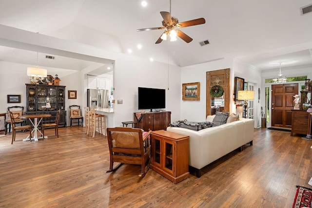 612 E 4th Ave, Covington, LA 70433 - living area featuring a chandelier, ceiling fan, wood finished floors, and vaulted ceiling