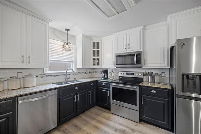 285 8th Street Dr, Ponchatoula, LA 70454 - kitchen with stainless steel appliances, a sink, dark cabinetry, and white cabinetry
