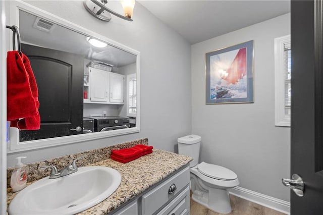 285 8th Street Dr, Ponchatoula, LA 70454 - half bathroom with wood finished floors, vanity, toilet, and baseboards