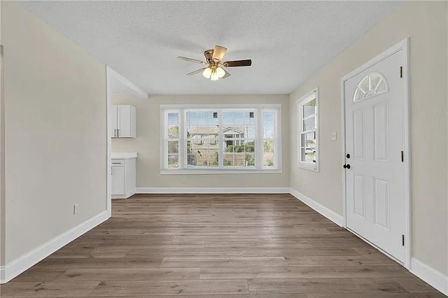 6073 Wickfield Dr, New Orleans, LA 70122 - entrance foyer featuring a ceiling fan, healthy amount of natural light, wood finished floors, and a textured ceiling