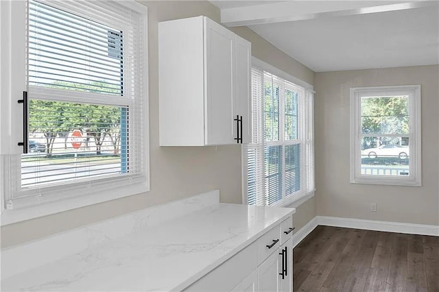 6073 Wickfield Dr, New Orleans, LA 70122 - kitchen featuring baseboards, dark wood-style flooring, white cabinets, light stone countertops, and beamed ceiling