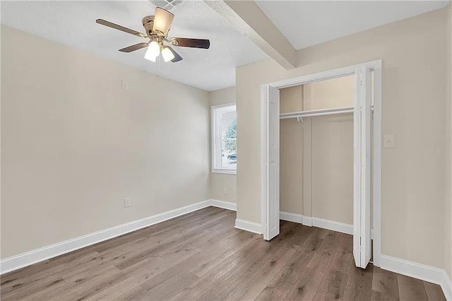 6073 Wickfield Dr, New Orleans, LA 70122 - unfurnished bedroom with wood finished floors, baseboards, a closet, and a ceiling fan