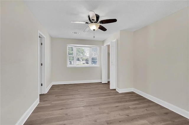 6073 Wickfield Dr, New Orleans, LA 70122 - unfurnished room with a ceiling fan, wood finished floors, and baseboards