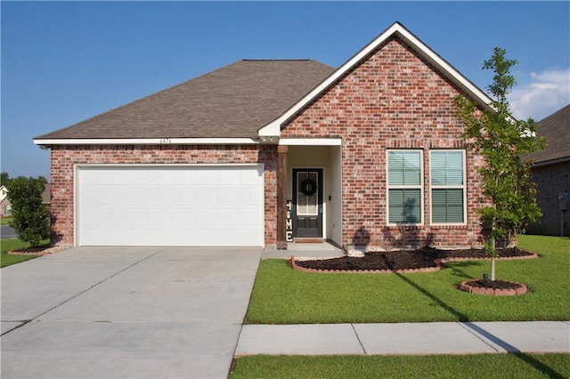 6476 Nesting Dr, Gonzales, LA 70737 - view of front of home with brick siding, concrete driveway, an attached garage, and a front lawn