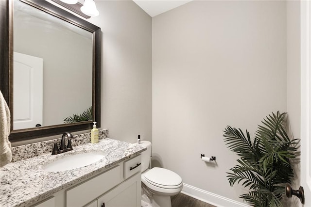 6476 Nesting Dr, Gonzales, LA 70737 - bathroom featuring vanity, toilet, baseboards, and wood finished floors