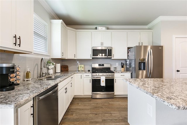 6476 Nesting Dr, Gonzales, LA 70737 - kitchen with appliances with stainless steel finishes, a sink, crown molding, white cabinets, and dark wood-type flooring