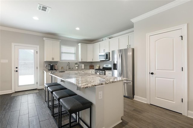 6476 Nesting Dr, Gonzales, LA 70737 - kitchen with appliances with stainless steel finishes, a sink, crown molding, a center island, and dark wood finished floors