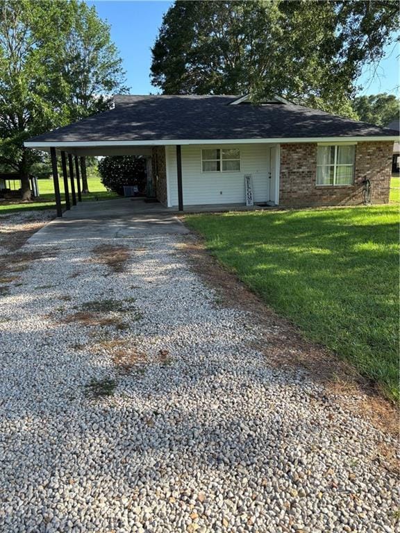 11036 Gulino Rd, Amite, LA 70422 - view of front of home featuring driveway, an attached carport, and a front lawn