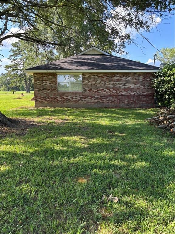 11036 Gulino Rd, Amite, LA 70422 - view of home's exterior featuring brick siding and a lawn