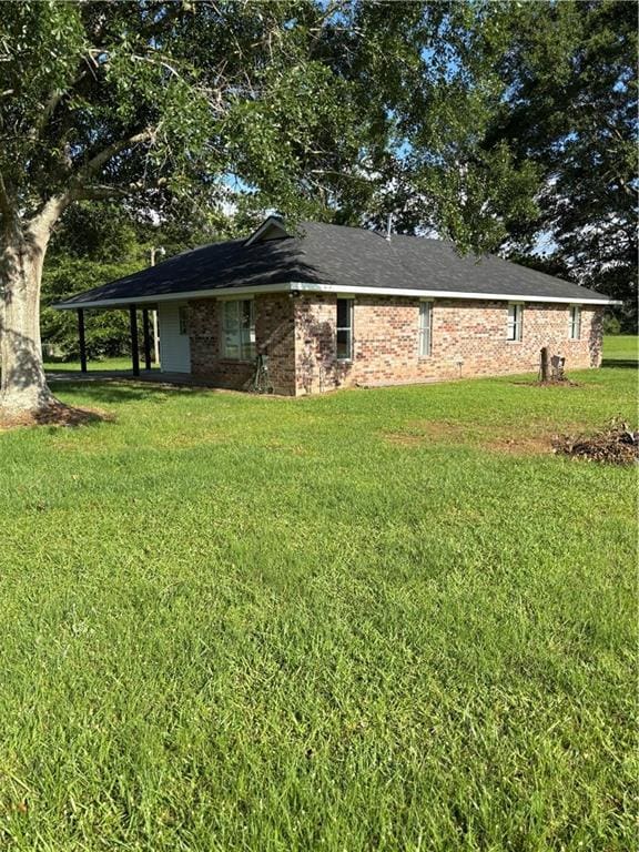 11036 Gulino Rd, Amite, LA 70422 - view of home's exterior with a yard and brick siding
