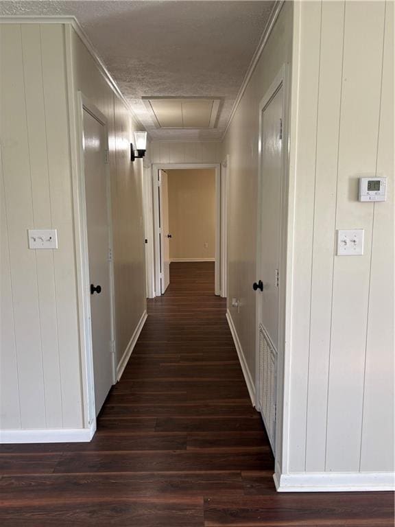 11036 Gulino Rd, Amite, LA 70422 - hall with crown molding, dark wood-style flooring, a decorative wall, a textured ceiling, and baseboards