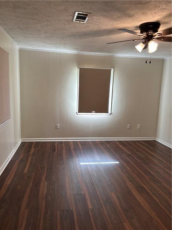 11036 Gulino Rd, Amite, LA 70422 - spare room featuring crown molding, dark wood-style floors, a textured ceiling, a ceiling fan, and baseboards